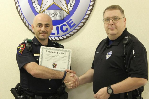 Maypearl Police Officer Shahid Mohamad (left) was presented the department's Lifesaving Award by Police Chief Kevin Coffey (right) for saving a woman's life on March 1, 2015.