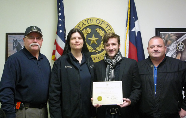 Shown are, from left, Ellis County Sheriff Johnny Brown, ECSO telecommunicator Heidi Smith, Matthew Smith and ECSO investigator Glen Smith.