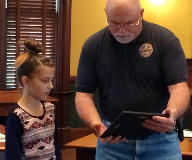 Ellis County Sheriff Johnny Brown (right) presented Camryn Samuel (left) with a plaque on Nov. 24, 2015 honoring her for raising funds to acquire ballistic vests for the Sheriff's Office two K9 units.